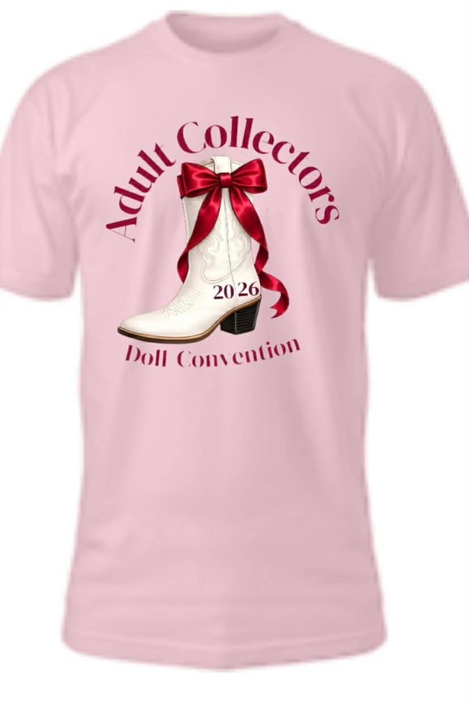 A pink t-shirt featuring a graphic of a white cowboy boot with a red bow, along with the text 'Adult Collectors 2026 Doll Convention'.